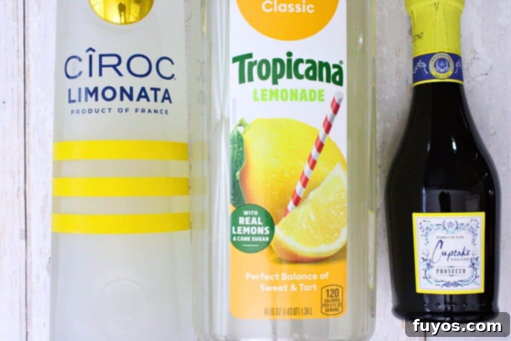 Zesty Sparkling Vodka Lemonade 4 Close-up of ingredients laid out for a vodka lemonade spritzer: Ciroc Limonata vodka bottle, prepared lemonade carton, and a bottle of prosecco.