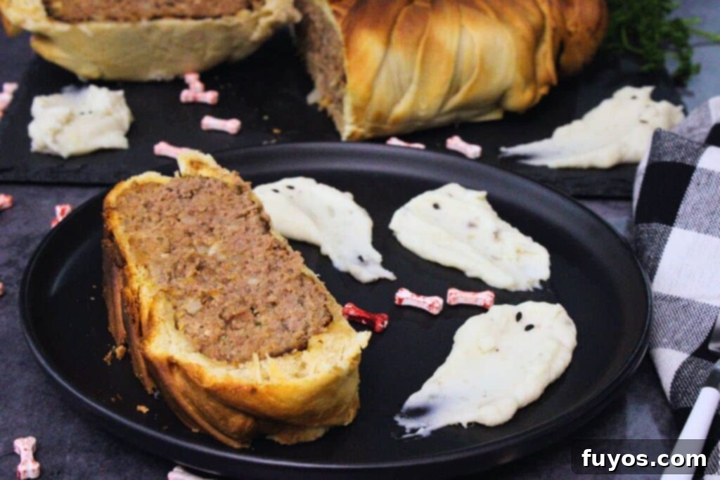 Spooky Halloween Air Fryer Mummy Meatloaf 3 slice of mummy meatloaf on a plate next to spooky mashed potato ghosts