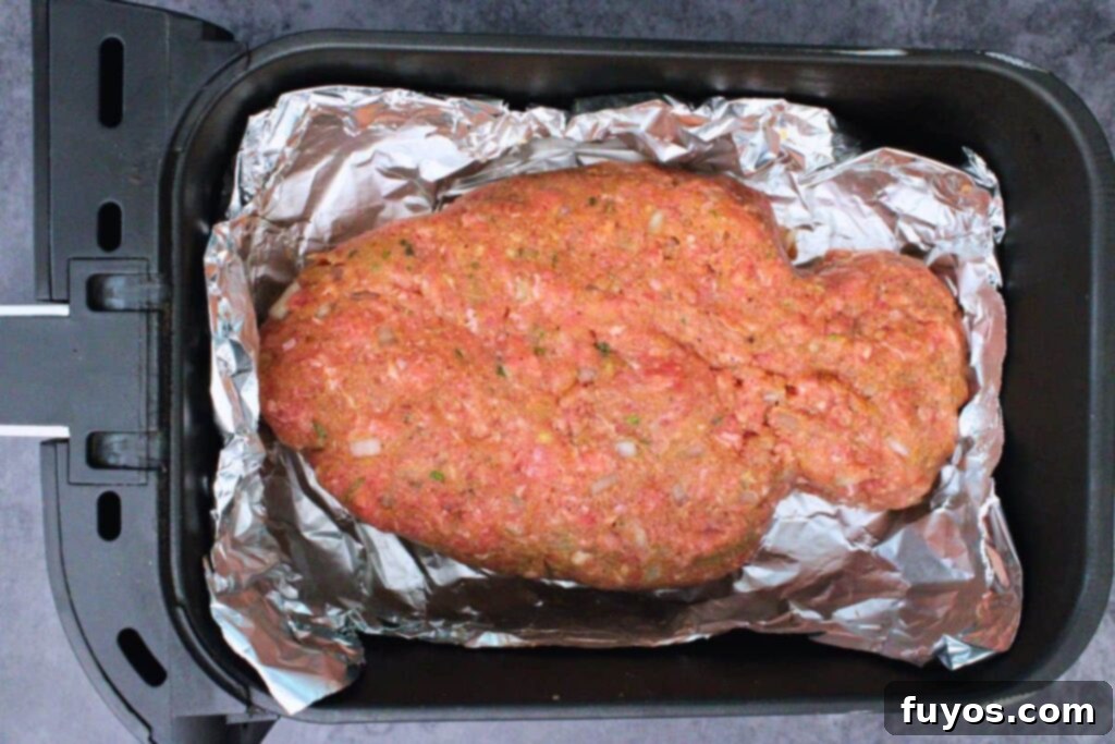 Spooky Halloween Air Fryer Mummy Meatloaf 7 place mummy meatloaf in air fryer basket