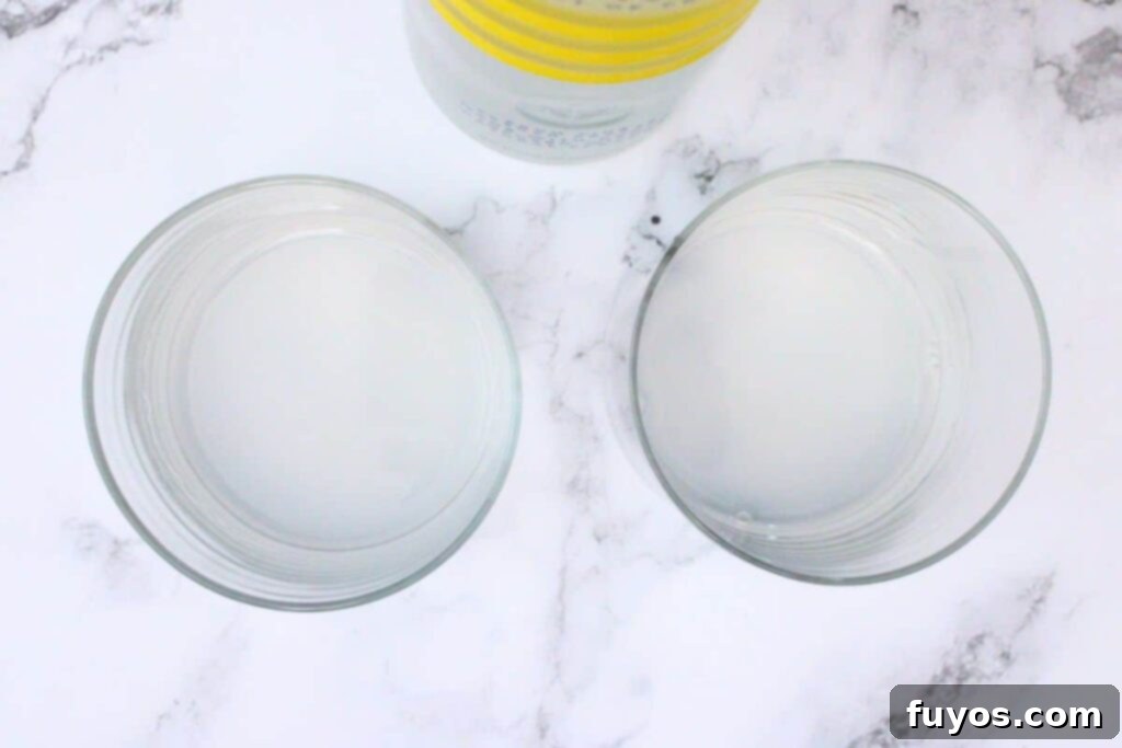 pouring Ciroc Limonata vodka into a lowball glass