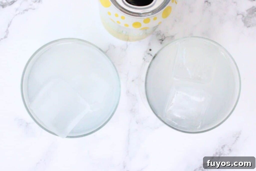 adding sparkling water to Ciroc Limonata vodka and ice in a glass