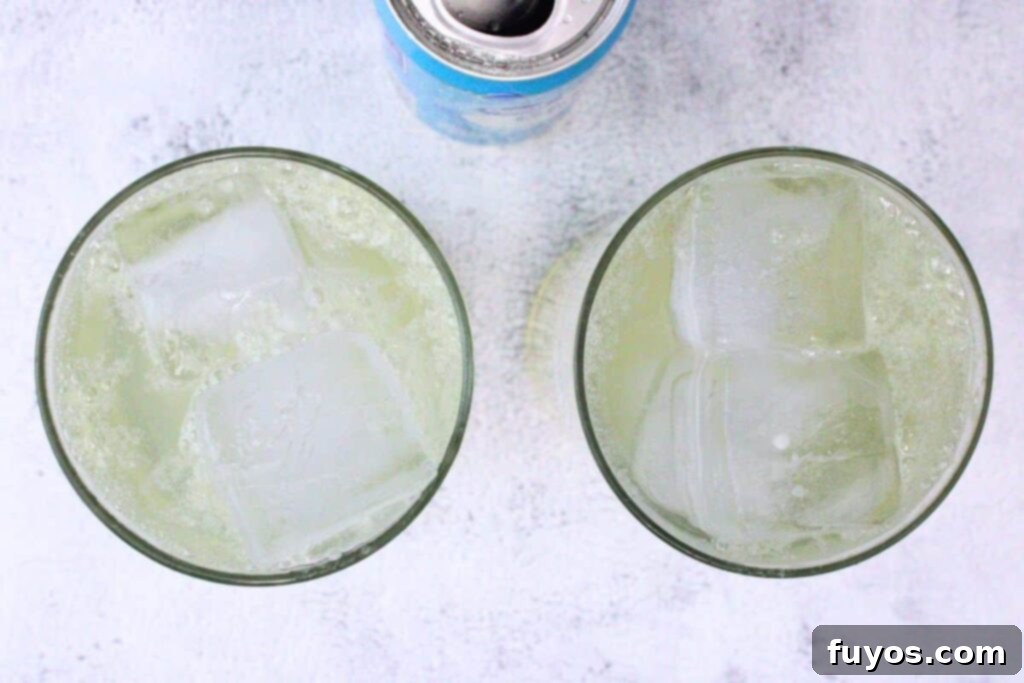 Lemon Vodka Collins: Summer's Zesty Escape 6 Filling a Collins glass with ice cubes and topping it with club soda