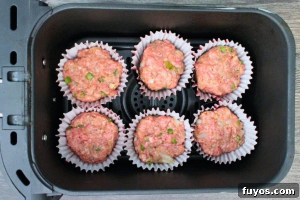 place filled meatloaf cups in air fryer basket