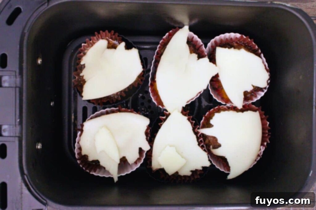 add provolone cheese to the top of cooked meatloaf cups and bake a few additional minutes
