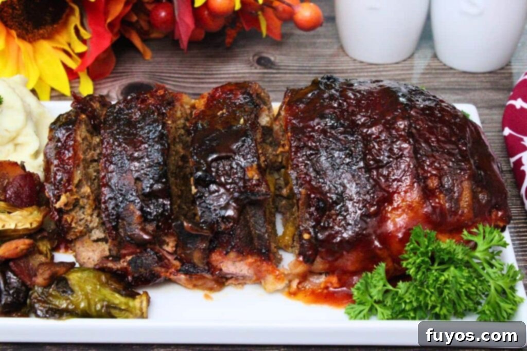 Bacon Wrapped Cheesy Stuffed Meatloaf Air Fryer Oven 3 side view of a bacon wrapped meatloaf lined up and cut into slices