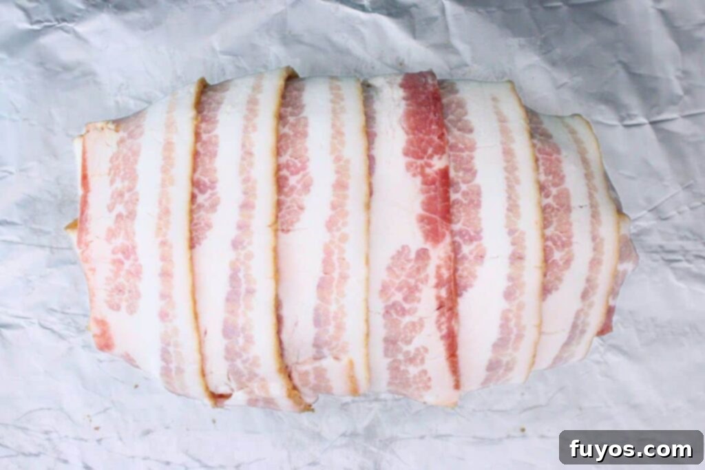 Bacon Wrapped Cheesy Stuffed Meatloaf Air Fryer Oven 7 cover meatloaf with bacon strips lengthwise and crosswise