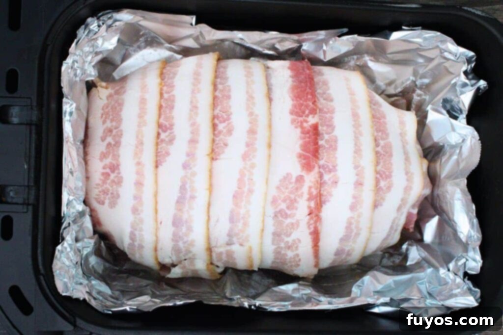 Bacon Wrapped Cheesy Stuffed Meatloaf Air Fryer Oven 8 place bacon wrapped meatloaf in air fryer basket
