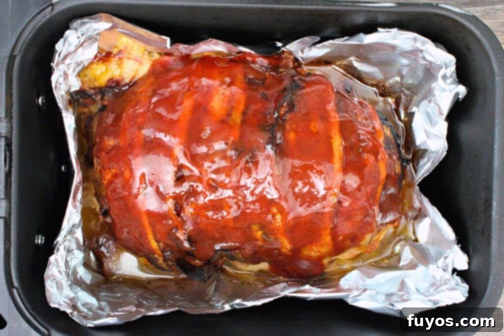 Bacon Wrapped Cheesy Stuffed Meatloaf Air Fryer Oven 9 brush ketchup glaze over top of meatloaf