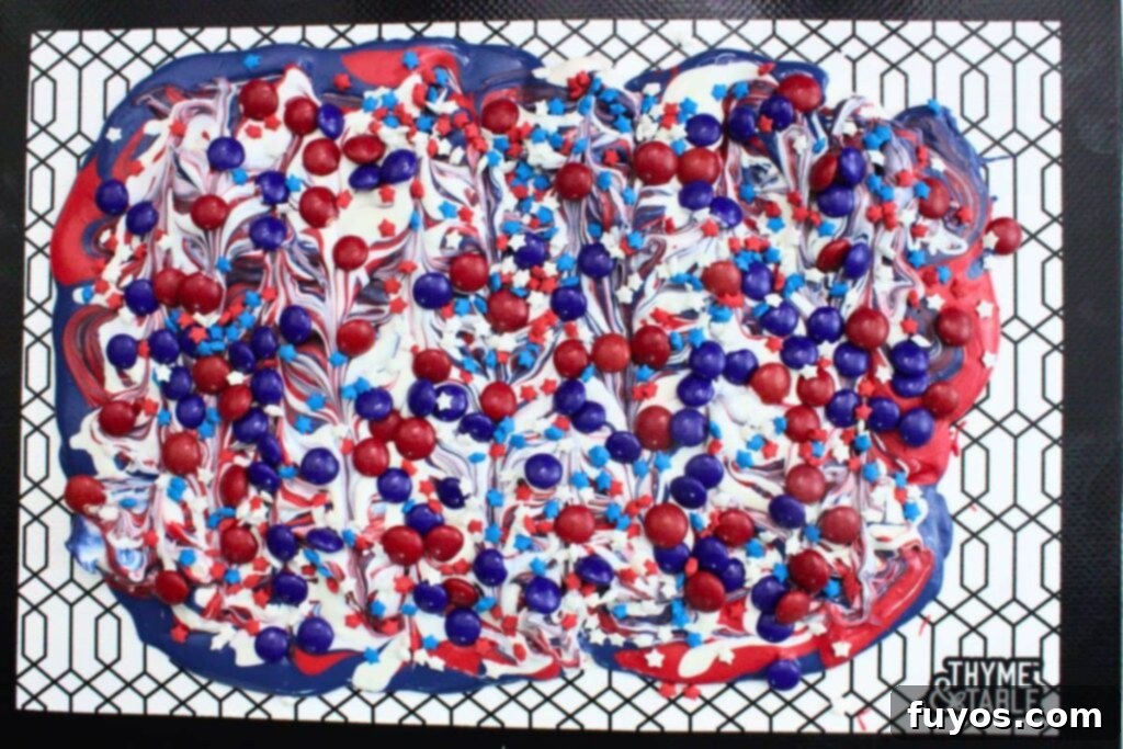 Red, White, and Blue Bark: Your Festive Fourth of July Dessert 6 alternate pouring chocolate colors on the mat and decorate with additional patriotic candy