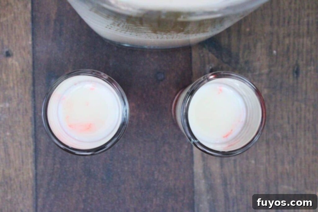 Stacked Red White Blue Party Shots 6 pour white chocolate liqueur over a spoon on top of red layer