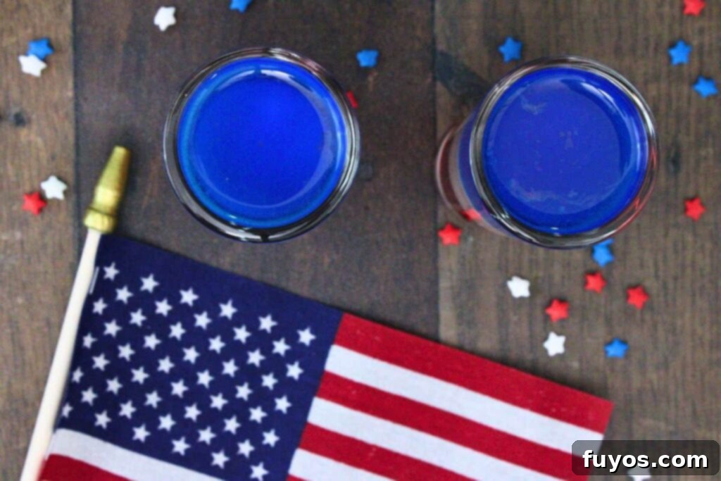 Stacked Red White Blue Party Shots 8 overhead view of two red white and blue shots showing the top blue curacao layer with an american flag