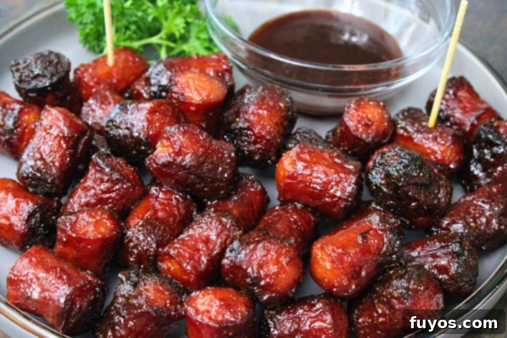 Air Fryer Hot Dog Burnt Ends A Speedy BBQ Spin 9 closeup view of hot dog burnt ends on a plate with bbq sauce for dipping