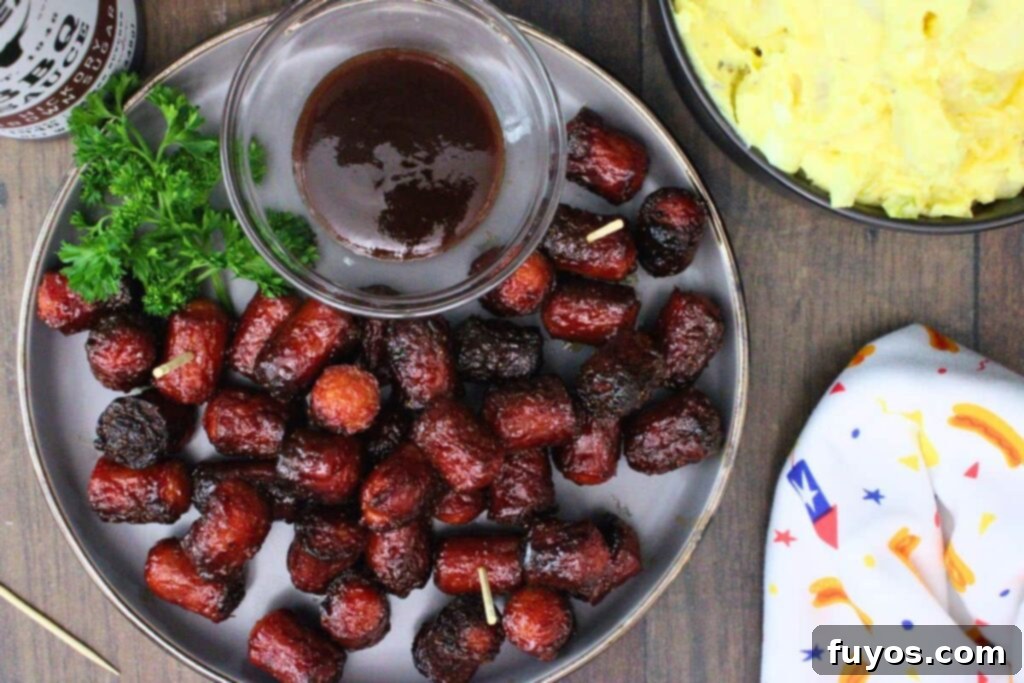 Air Fryer Hot Dog Burnt Ends A Speedy BBQ Spin 8 overhead view of hot dog burnt ends on a plate with bbq sauce and a side of potato salad