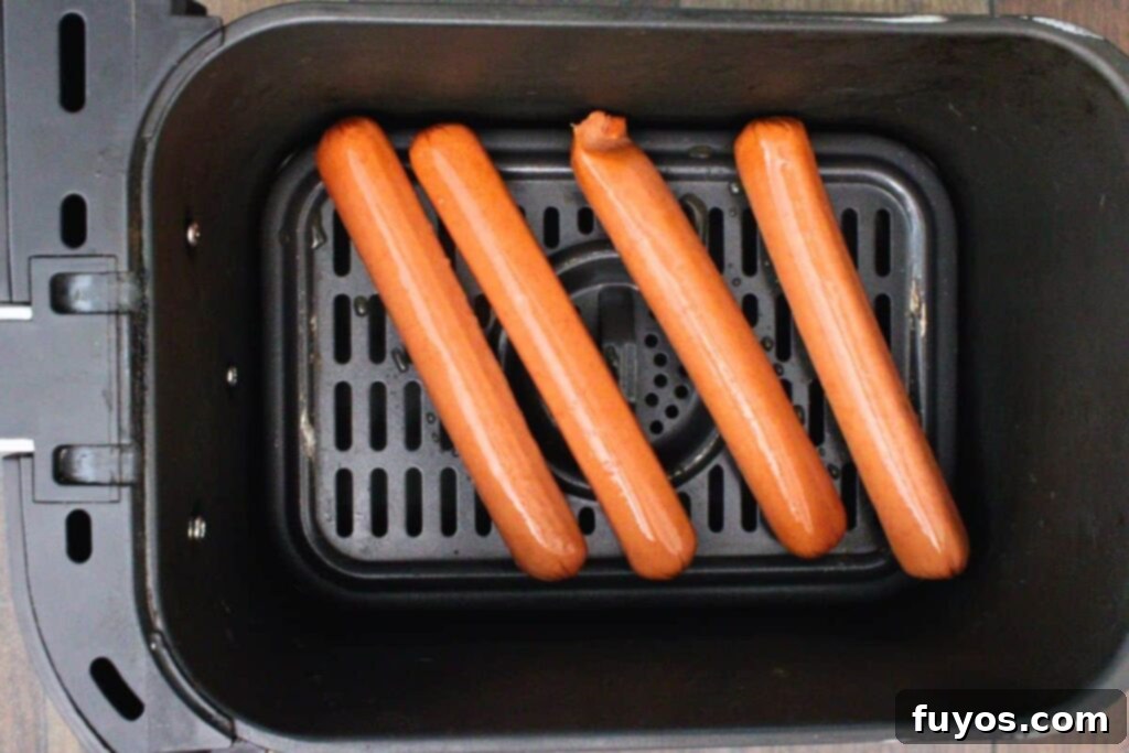 Pizza Hot Dogs: Your Go-To 30-Minute Flavor Fusion 5 place hot dogs in air fryer basket leaving space in between