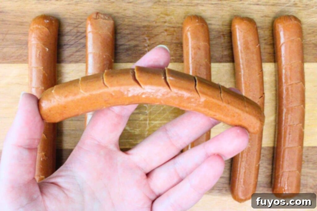 Flavor-Packed Air Fryer Franks 5 use a sharp knife to cut angled slits in the hot dog