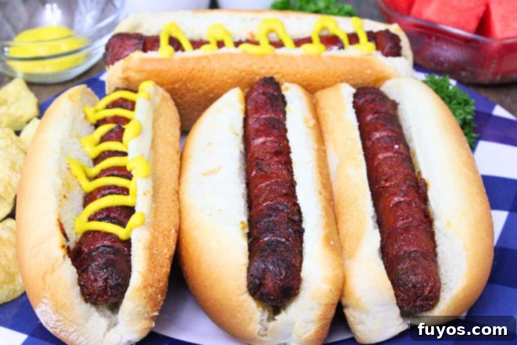 Flavor-Packed Air Fryer Franks 9 plate of juicy marinated hot dogs side by side in fluffy buns