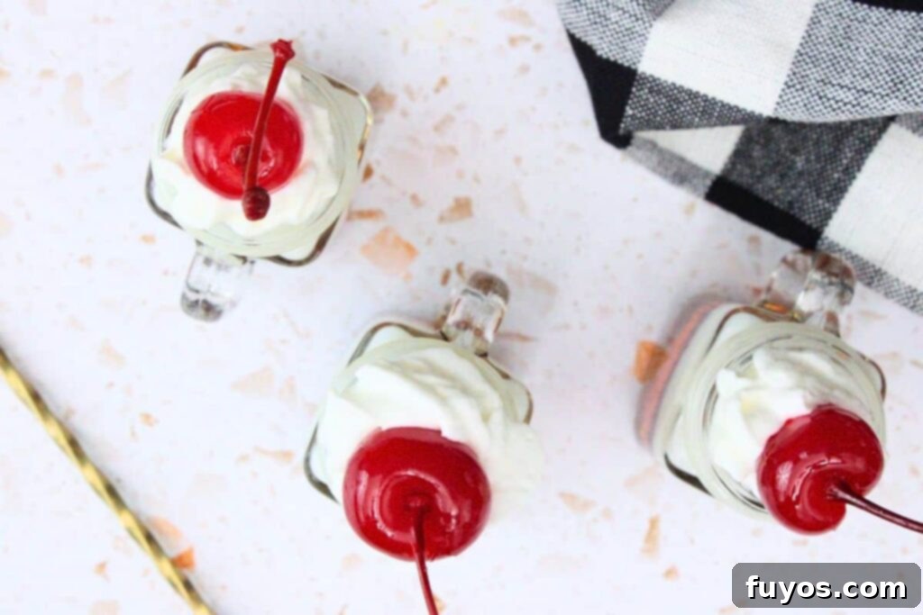 Grown-Up Root Beer Float Shots: A Sip of Summer Nostalgia 7 top root beer float shots with whipped cream and cherry