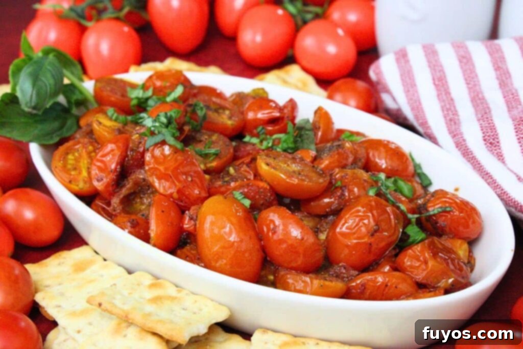 serving dish filled with roasted air fryer cherry tomatoes topped with fresh basil