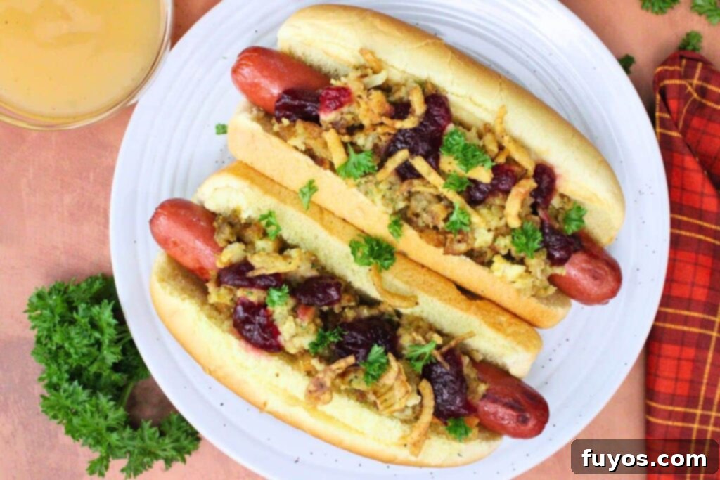 Air Fryer Thanksgiving Hot Dogs: Effortless Holiday Eats 8 overhead view of two air fryer thanksgiving hot dogs topped with stuffing and cranberry sauce