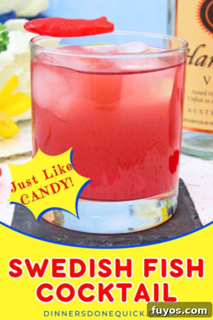 Vibrant Swedish Fish cocktail, garnished with candy, perfect for Pinterest sharing.