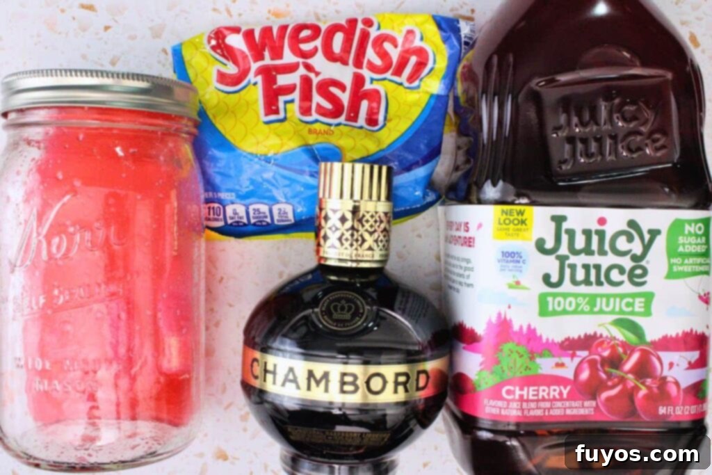 All the vibrant ingredients laid out for making the Swedish Fish cocktail, including infused vodka, cherry juice, Chambord, and gummy candies.