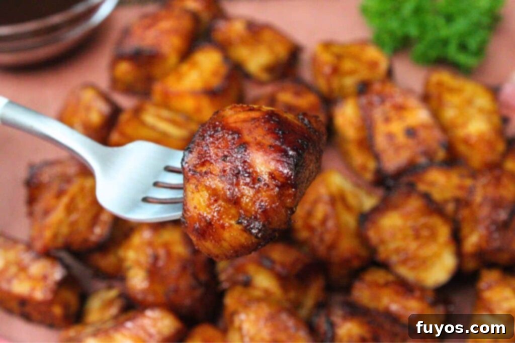 Air Fryer Turkey Burnt Ends: Crispy, Smoky Perfection 3 holding up a fork with a juicy piece of turkey burnt ends
