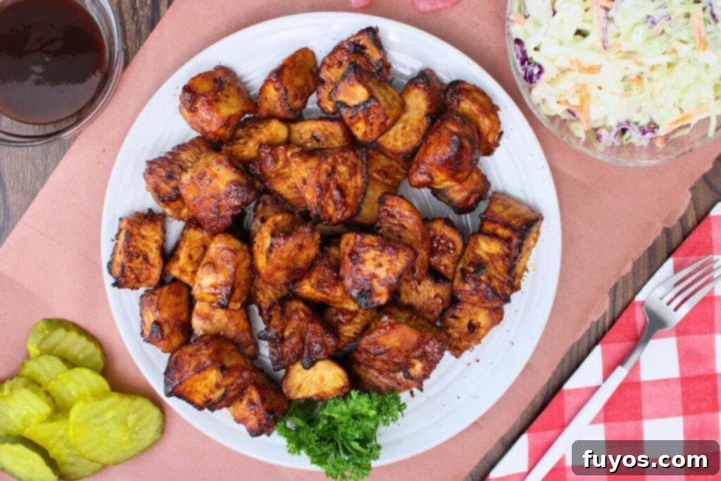 Air Fryer Turkey Burnt Ends: Crispy, Smoky Perfection 9 overhead view of a plate of air fryer turkey burnt ends next to pickles and coleslaw