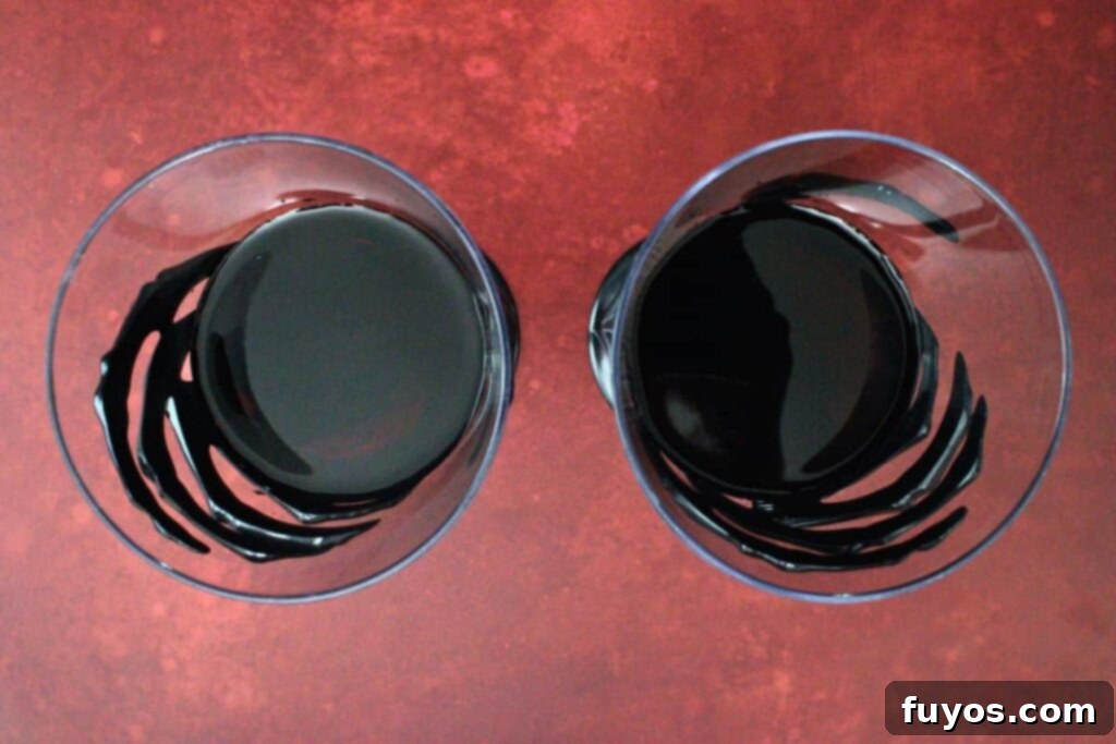 Midnight Ritual Sangria A Bewitching Adult Brew 5 add wine and vodka to spooky themed glasses