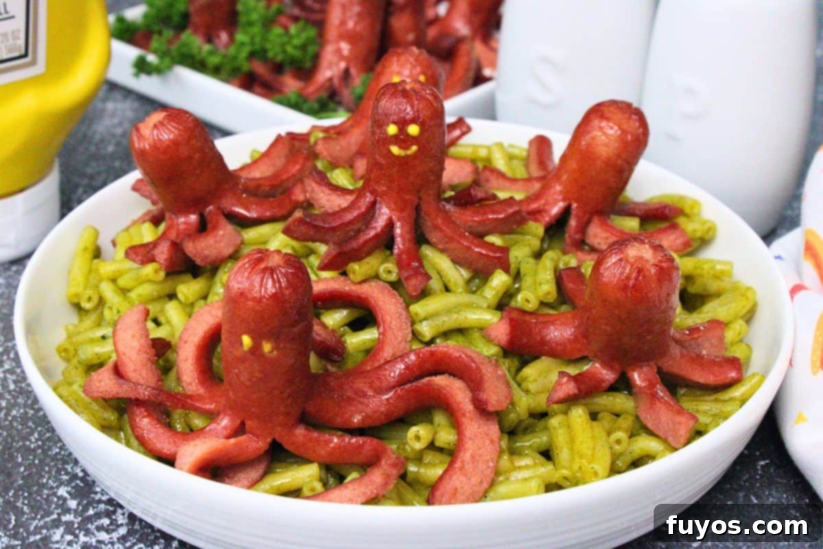 27 Irresistible Air Fryer Hot Dog Creations 19 several octopus hot dogs over a bowl of green macaroni and cheese