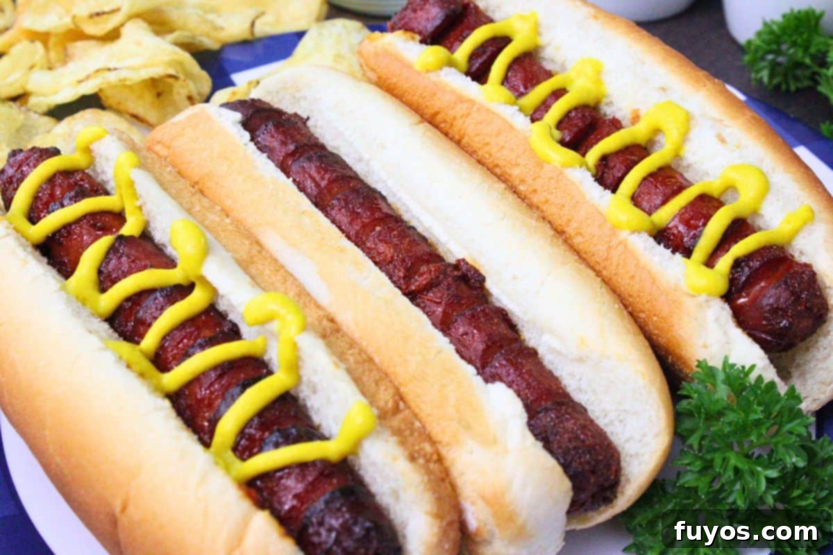 27 Irresistible Air Fryer Hot Dog Creations 8 three marinated hot dogs side by side with the two on each end topped with a mustard swirl