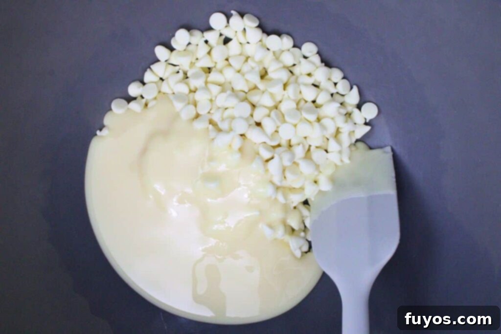 Poison Apple Fudge: A Hauntingly Easy No-Bake Treat 5 add half of sweetened condensed milk and white chocolate chips to microwave safe bowl