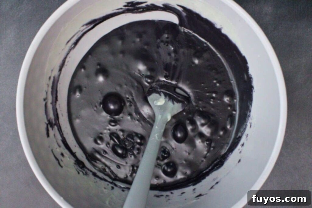 Poison Apple Fudge: A Hauntingly Easy No-Bake Treat 9 add remaining chocolate and sweetened condensed milk to separate bowl and add black food coloring