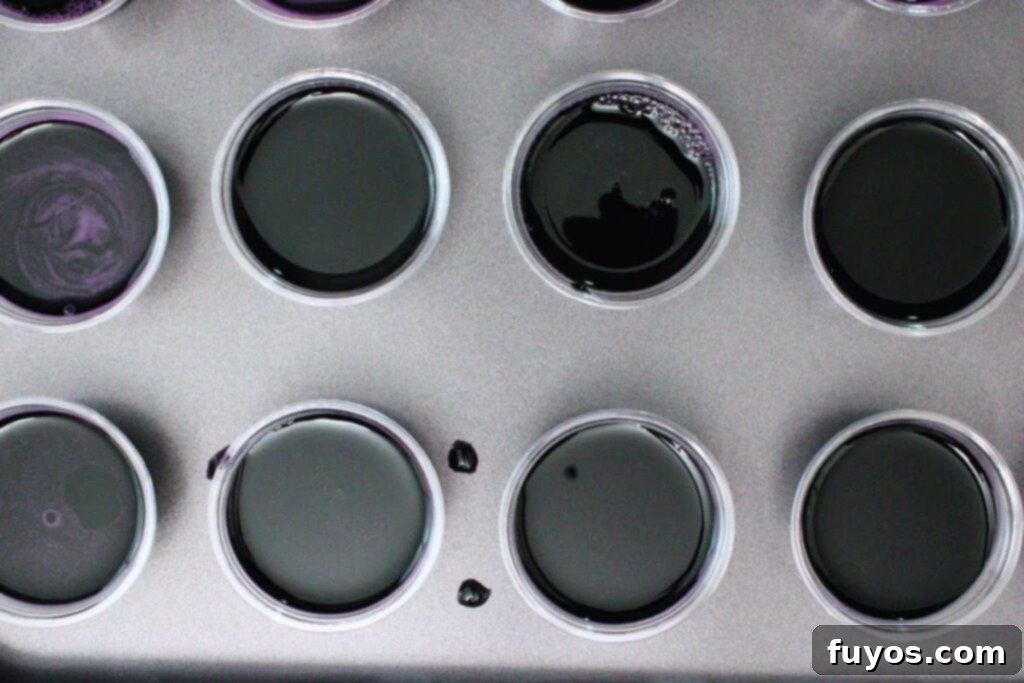 pour black jello mixture into jello shot cups