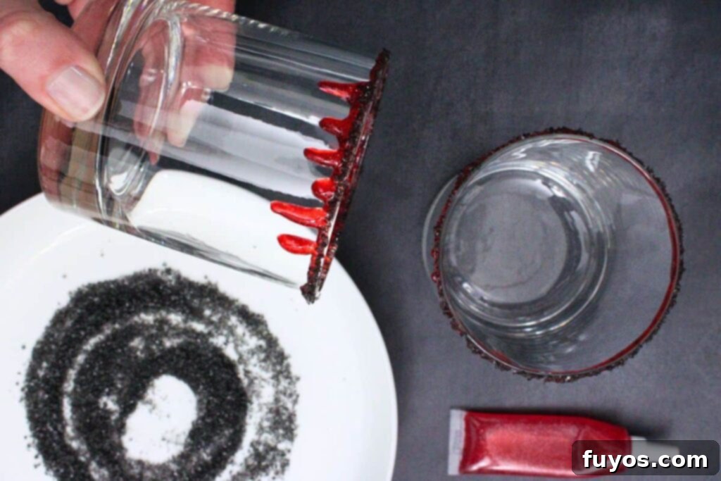 rim bloody tequila sunset glass with red decorating gel and black salt