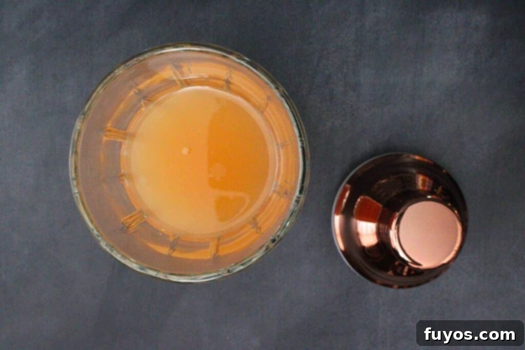 add tequila, grapefruit juice, and coconut cream to cocktail shaker