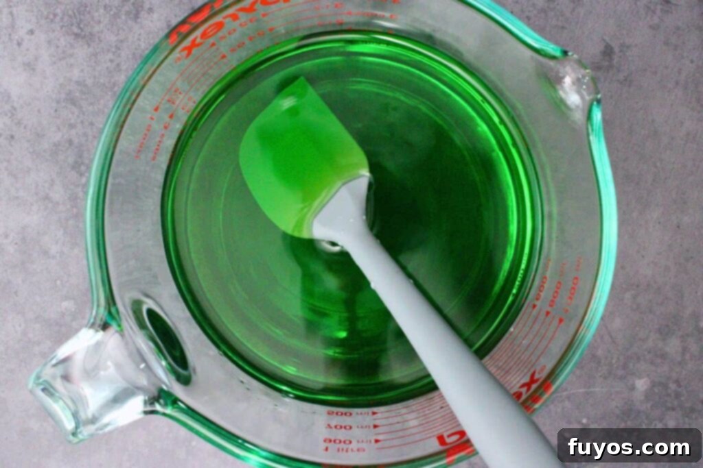 Poison Apple Jello Shots: An Adult Halloween Delight 6 pour cold water and vodka into green jello mix