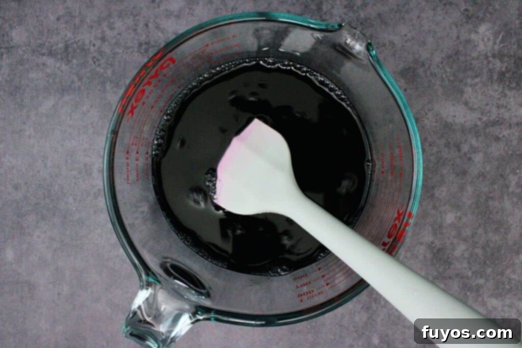 Poison Apple Jello Shots: An Adult Halloween Delight 8 add remaining jello to boiling water and add black food coloring and vodka