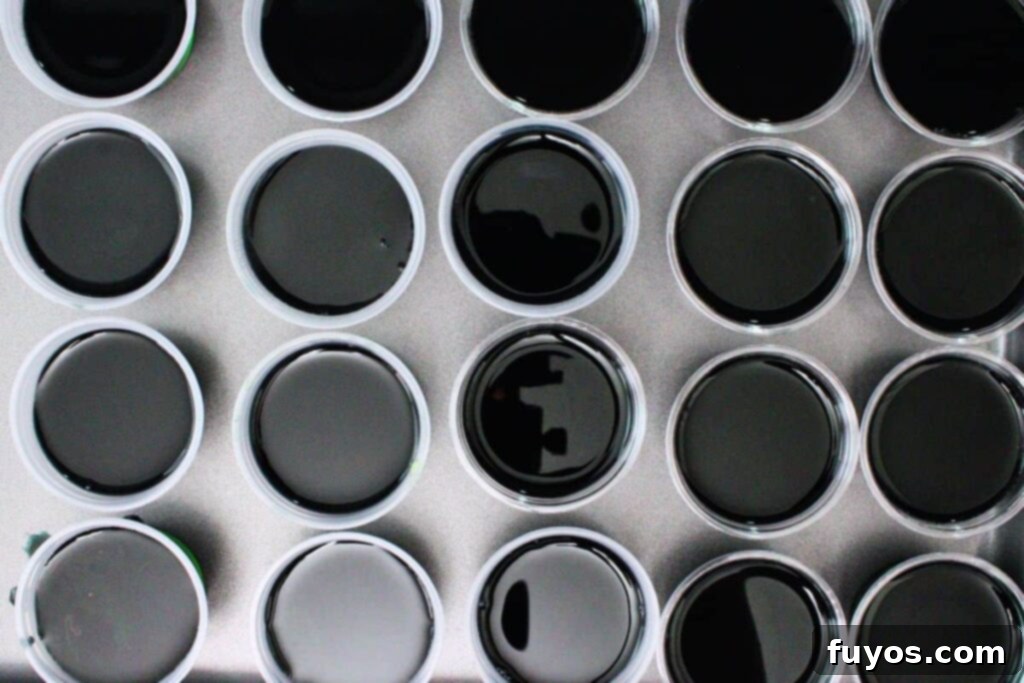 Poison Apple Jello Shots: An Adult Halloween Delight 9 carefully pour black jello layer over green layer