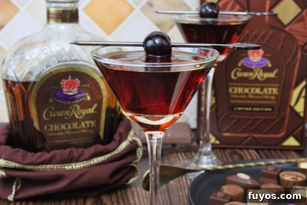 Crown Royal Chocolate Manhattan 3 closeup view of chocolate manhattan cocktail with cherry skewer in front of chocolate crown royal bottle