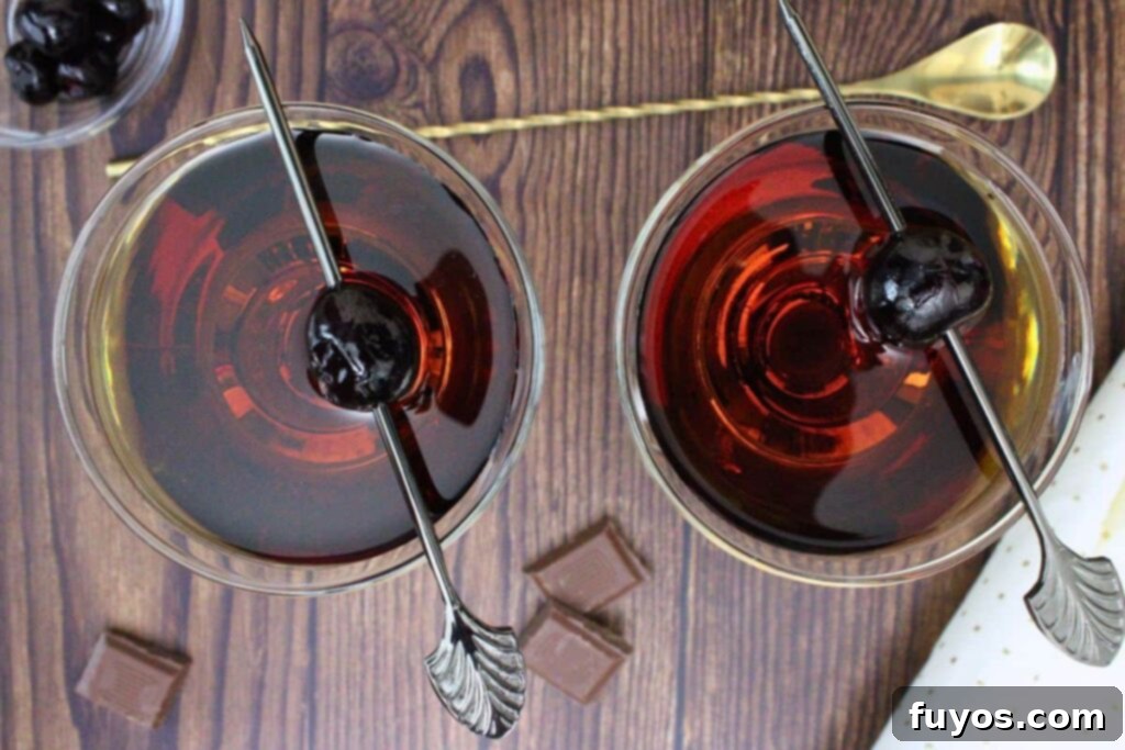 Crown Royal Chocolate Manhattan 7 overhead view of two chocolate manhattans garnished with luxardo cherry on a wooden table