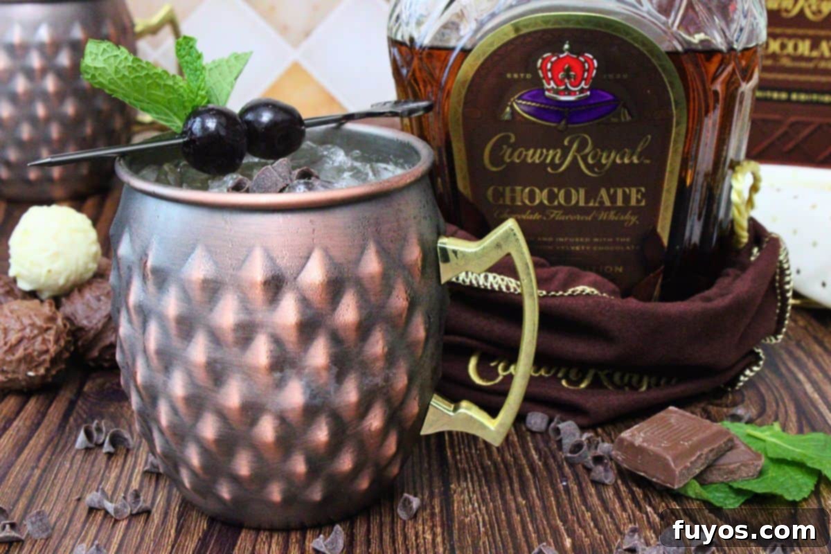 chocolate mule in a copper mug with a cherry skewer next to chocolate crown royal bottle