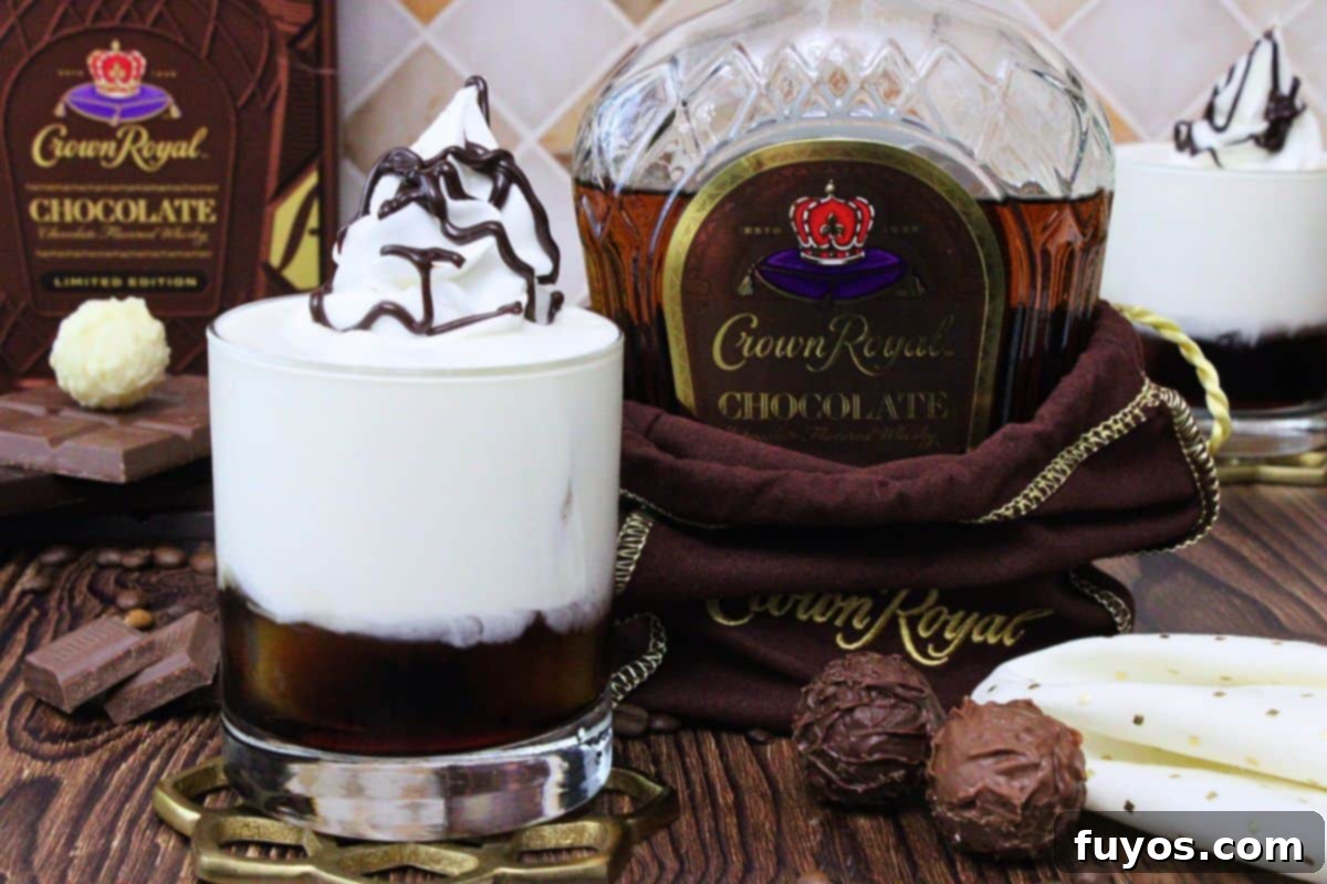 crown royal chocolate white russian with whipped cream and chocolate drizzle next to new whisky bottle and chocolate truffles