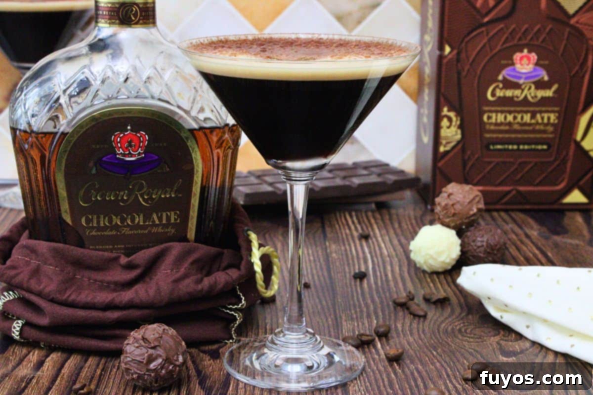 chocolate espresso martini with cocoa dusting next to chocolate crown royal bottle