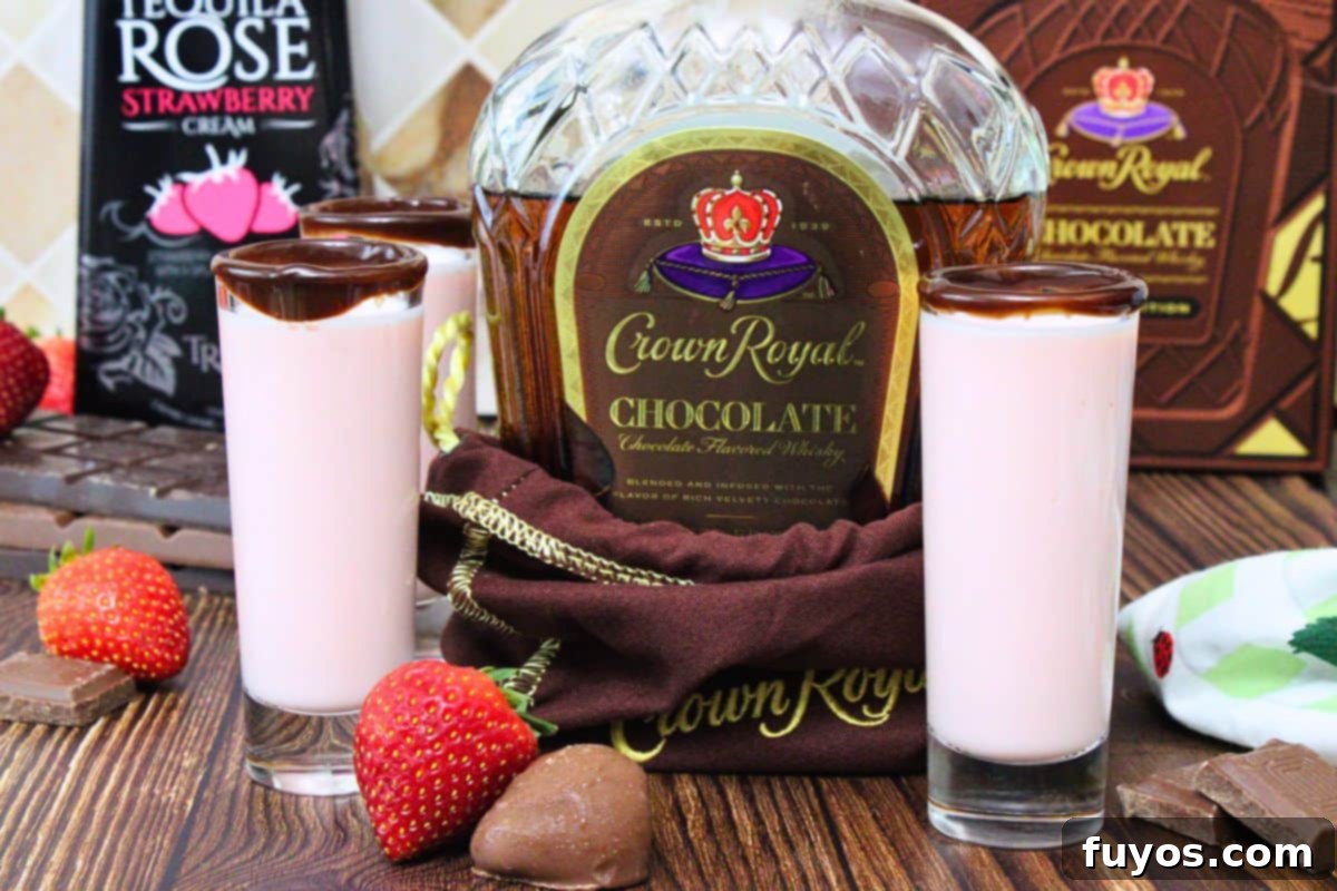 chocolate crown royal bottle surrounded by chocolate covered strawberry shots with a chocolate rim