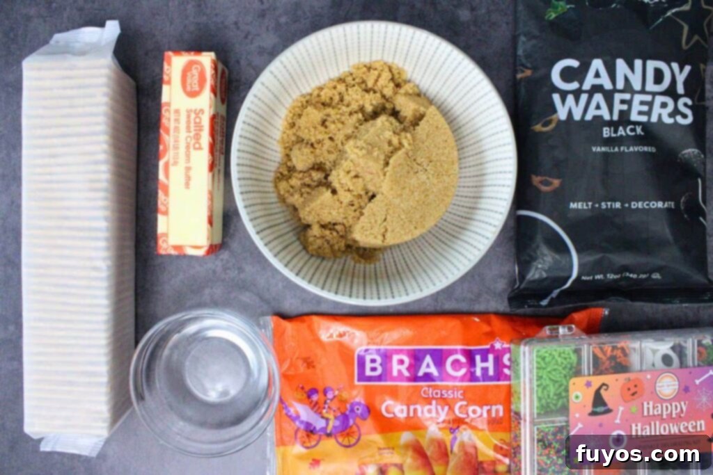 No Bake Halloween Saltine Crack Toffee 4 Ingredients laid out to make Halloween crack including saltines, butter, brown sugar, black candy melts, and various Halloween candies.