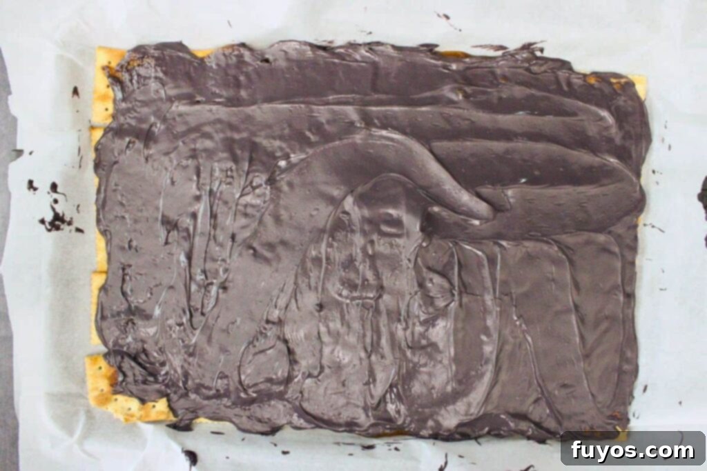 No Bake Halloween Saltine Crack Toffee 8 Adding black candy melts on top of the hot toffee layer and then spreading them evenly with a spatula after they begin to melt.