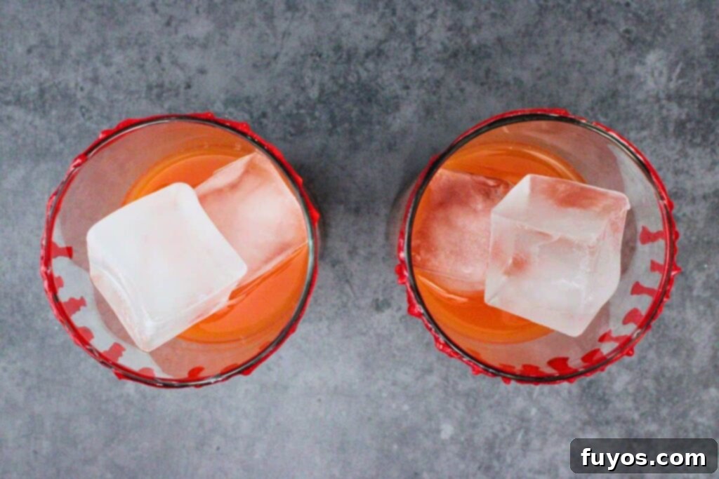 fill glass with ice blood orange juice and tequila
