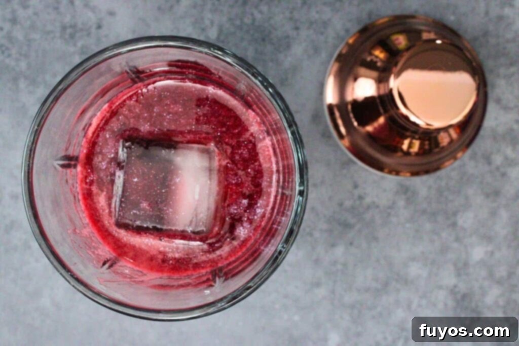 Disney's Spooky Black Magic Margarita 7 add blackberry puree to cocktail shaker with tequila, cassis liqueur, and luster dust