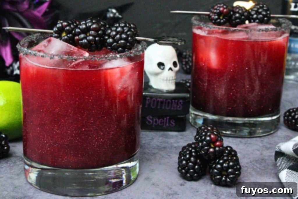Disney's Spooky Black Magic Margarita 10 two black magic margaritas with shimmering luster dust with halloween skull decoration in between