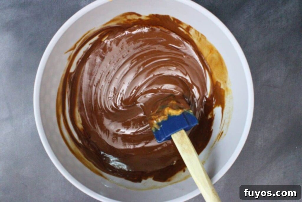 Mummy's Muddy Munch 5 combine semisweet chocolate chips, butter, and peanut butter in a bowl